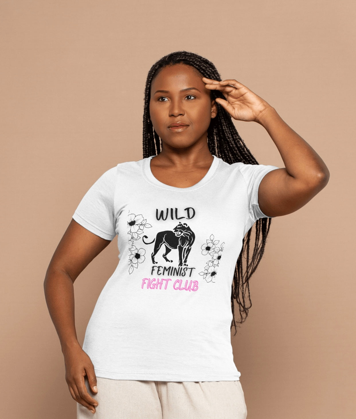 Woman wearing a white t-shirt with 'Wild Feminist Fight Club' design on a beige background