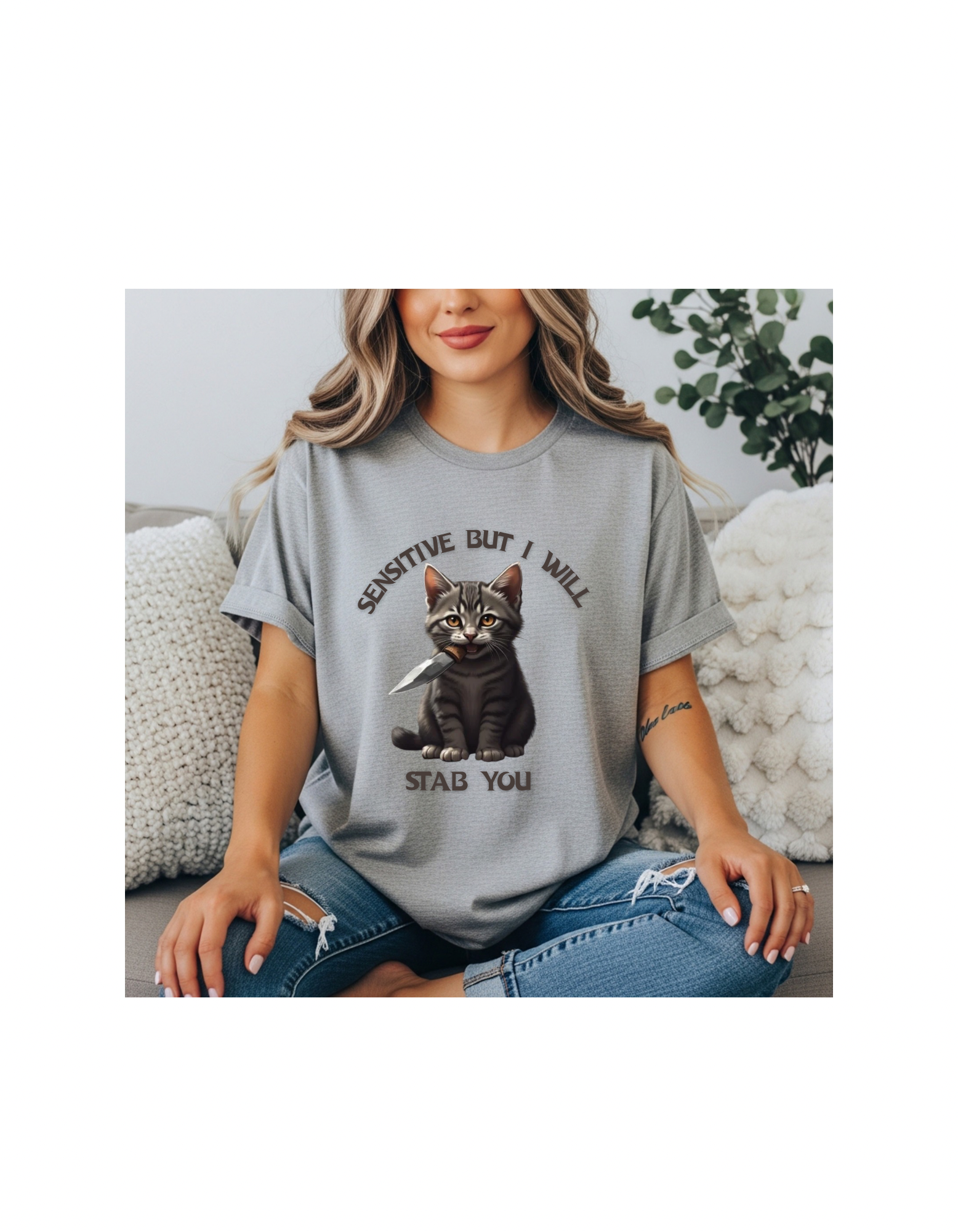 Women’s light gray t-shirt with a cat graphic and text that reads “sensitive but I will stab you”