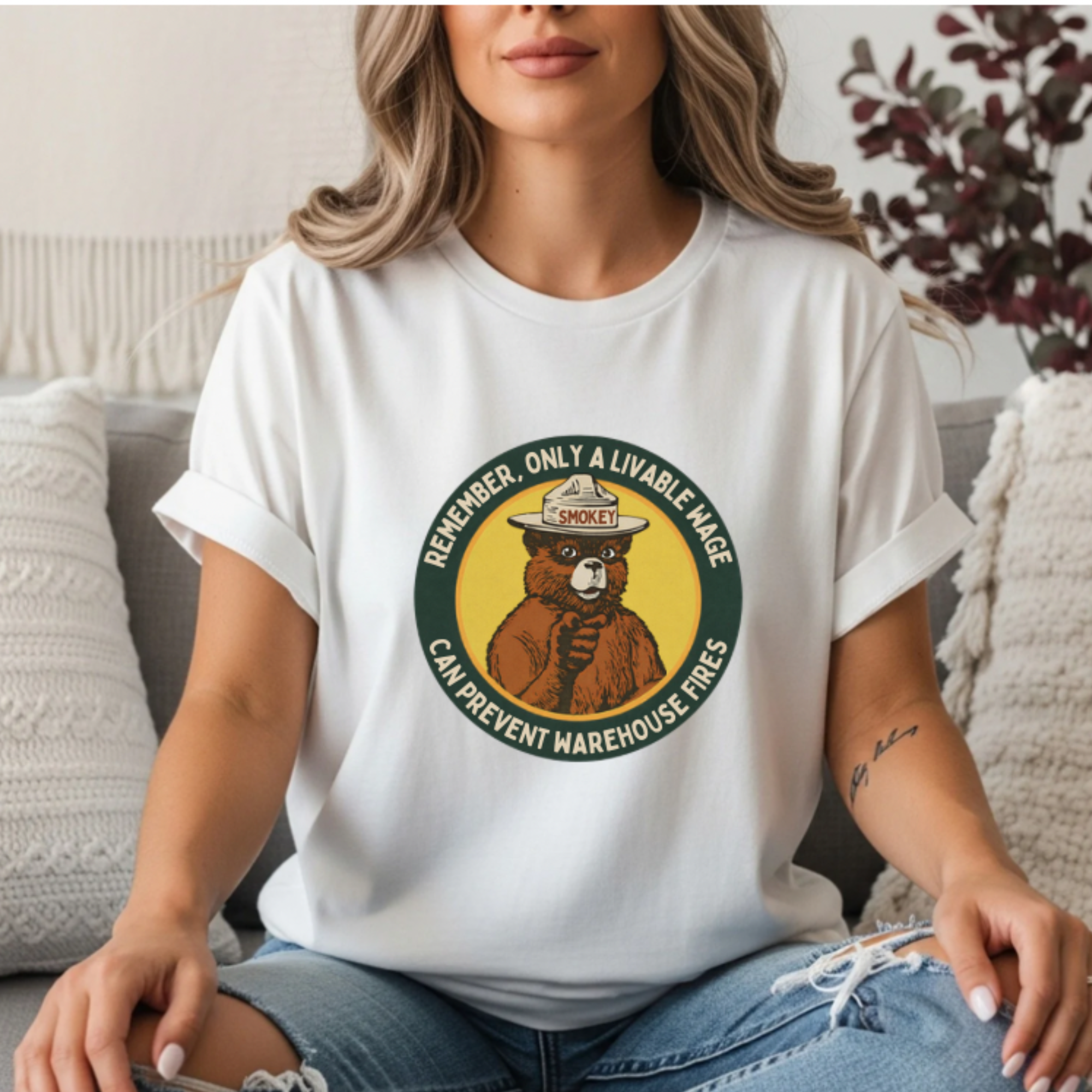 White graphic tee featuring a Smokey Bear parody badge design. Text reads “Remember, Only a Livable Wage Can Prevent Warehouse Fires.” Funny labor rights shirt, workers’ rights tee, sarcastic anti-Amazon shirt, pro-union graphic tee, funny political gift.