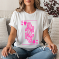 white graphic tee featuring a bold hot pink Queen of Hearts playing card design with a crowned skeleton queen, roses, and skulls. Edgy feminine shirt, skeleton queen tee, dark glam graphic shirt, witchy women’s gift, bold statement shirt for women