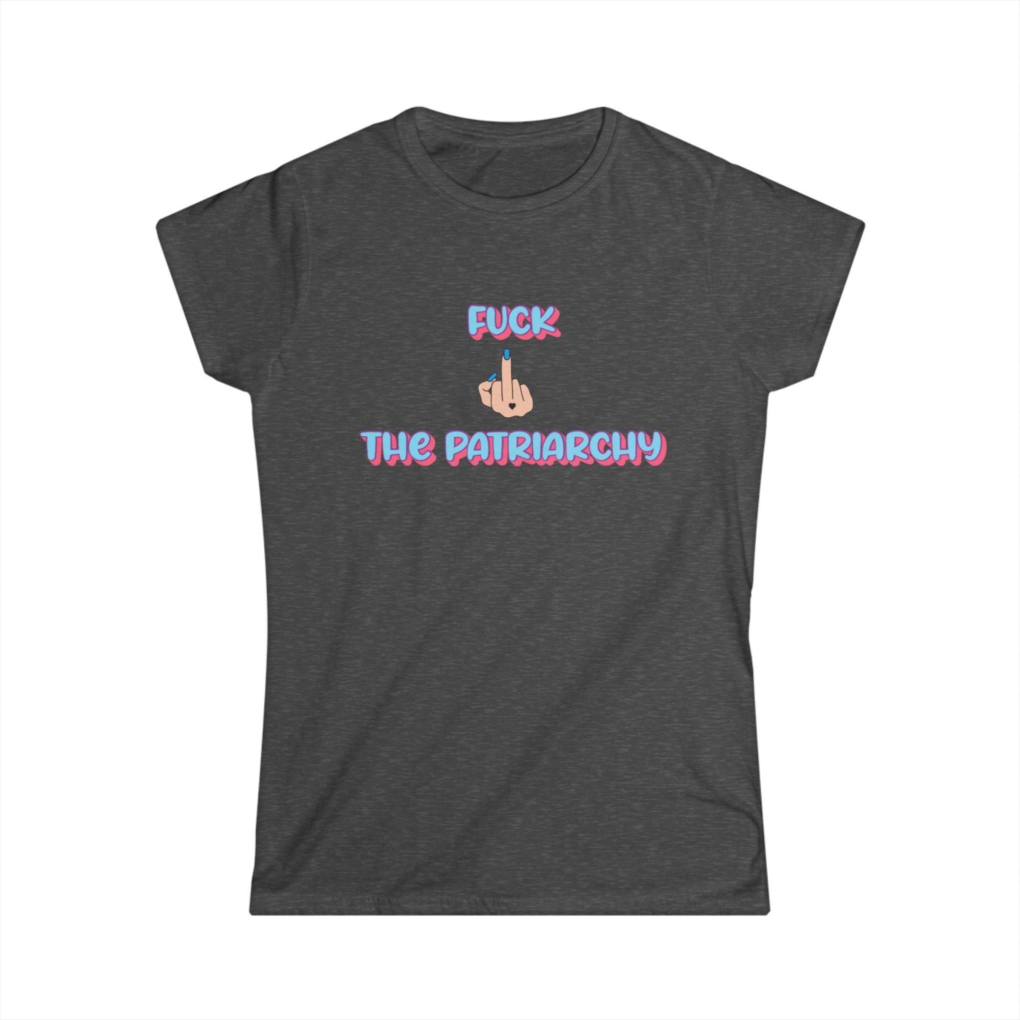 Women’s dark gray tee with “F*ck The Patriarchy” printed in pink and blue gradient bubble letters with an illustrated middle finger graphic between the words, modeled by a woman seated casually in jeans.
