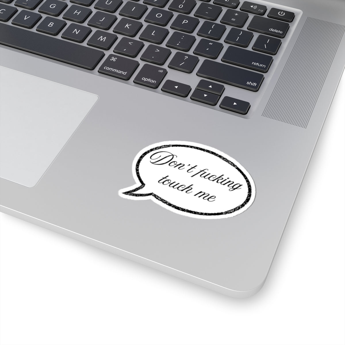 Laptop with a sticker saying 'Don't fucking touch me' on the palm rest area.