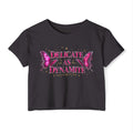 Black crop top with pink butterfly design and text 'Delicate as Dynamite' 
